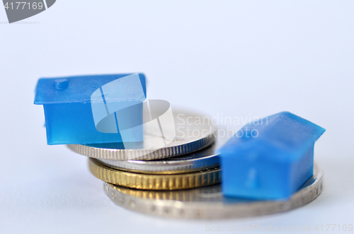 Image of Little plastic house on metal coins