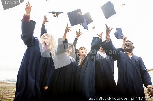 Image of happy students throwing mortar boards up