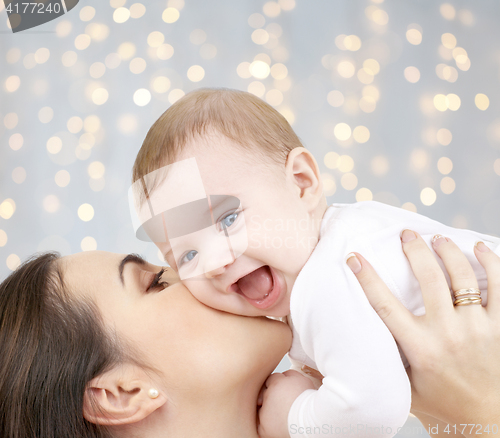 Image of happy mother kissing adorable baby