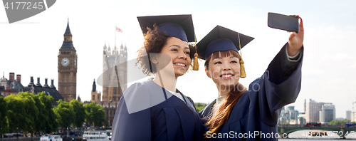 Image of bachelors taking selfie by smartphone in london