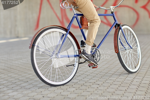 Image of close up of hipster man riding fixed gear bike