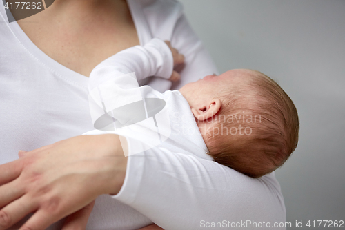 Image of close up of mother holding newborn baby