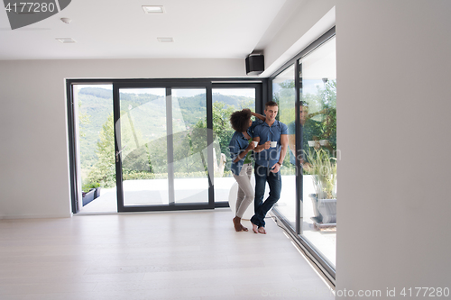 Image of romantic happy young couple relax at modern home indoors