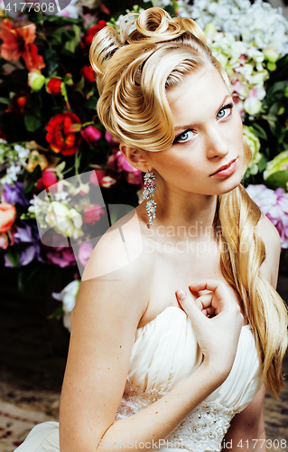 Image of beauty young woman bride alone in luxury vintage interior with a lot of flowers close up