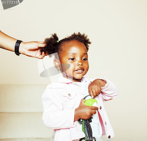 Image of little cute sweet african-american girl playing happy with toys 