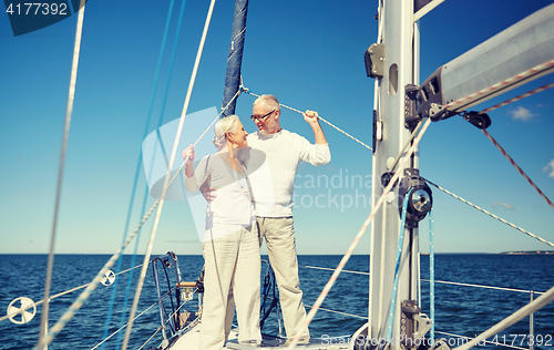 Image of senior couple hugging on sail boat or yacht in sea