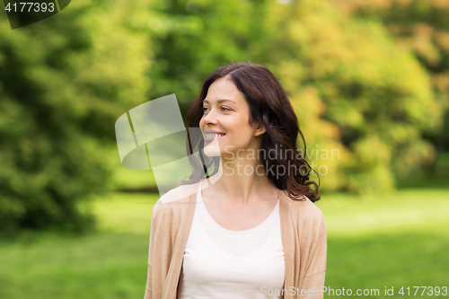 Image of beautiful happy young woman in summer park