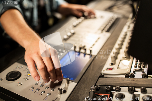 Image of man using mixing console in music recording studio