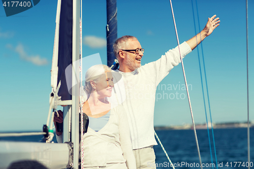 Image of senior couple hugging on sail boat or yacht in sea