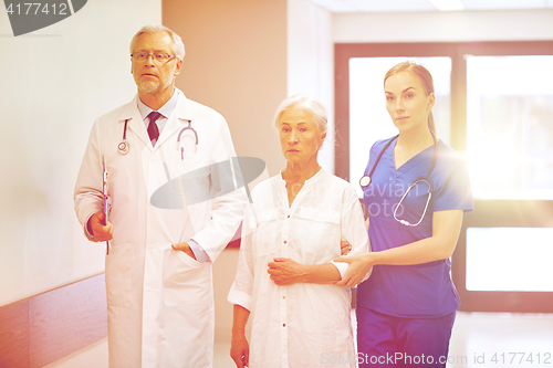 Image of medics and senior patient woman at hospital