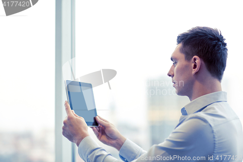 Image of businessman with tablet pc in office