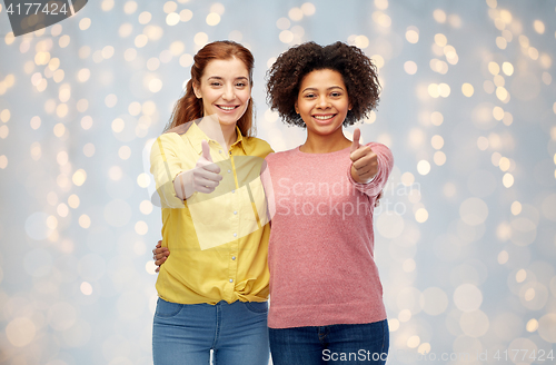 Image of happy smiling women showing thumbs up