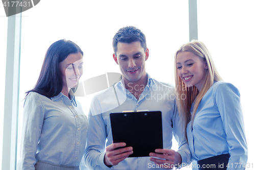 Image of business team looking at clipboard