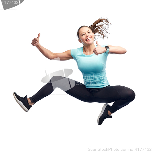 Image of happy smiling sporty young woman jumping in air