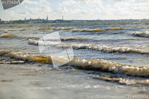 Image of baltic sea waves and tallinn city outlines