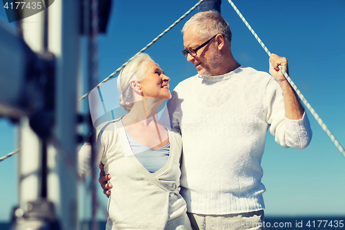 Image of senior couple hugging on sail boat or yacht in sea