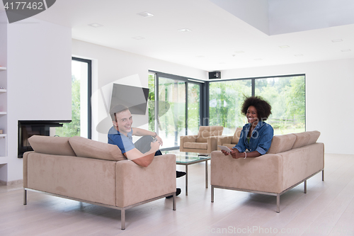 Image of multiethnic couple in living room