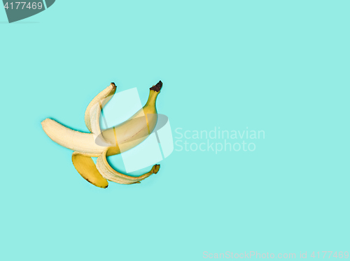 Image of Single banana against blue background