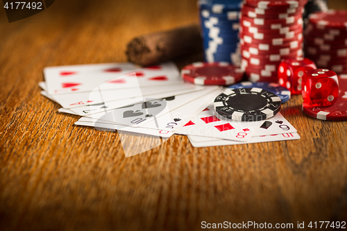 Image of Cigar, chips for gamblings, drink and playing cards