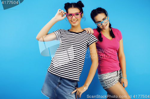 Image of best friends teenage girls together having fun, posing emotional on blue background, besties happy smiling, lifestyle people concept 