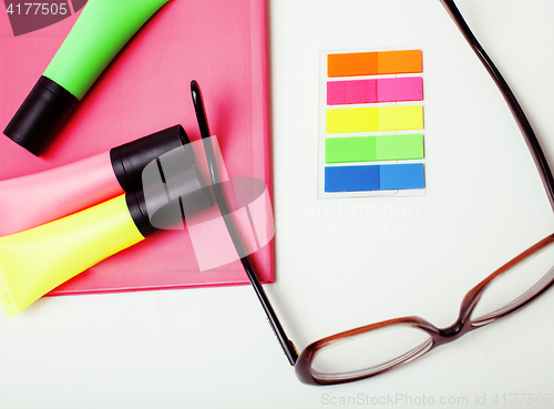 Image of business, education and technology concept - close up of notebook, paper stickers, glasses, pencil different stuff on white background