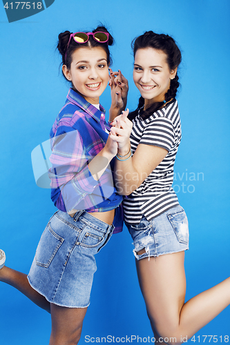 Image of best friends teenage girls together having fun, posing emotional on blue background, besties happy smiling, lifestyle people concept 