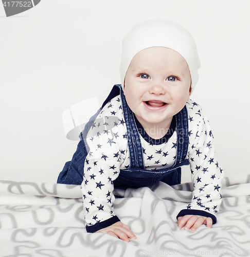 Image of little cute baby toddler on carpet isolated close up smiling ado