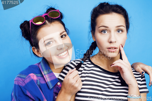 Image of best friends teenage girls together having fun, posing emotional on blue background, besties happy smiling, lifestyle people concept 