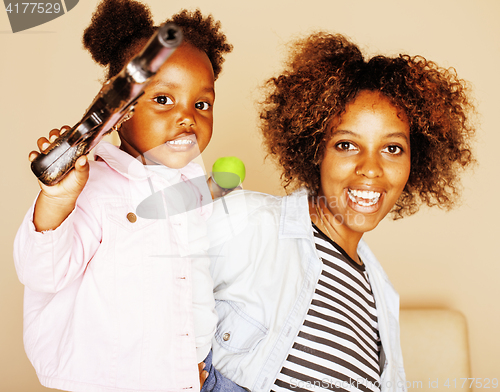 Image of adorable sweet young afro-american mother with cute little daughter, hanging at home, having fun playing smiling, lifestyle people concept, happy smiling modern family 