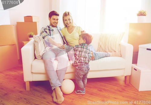 Image of happy family moving to new home and playing ball