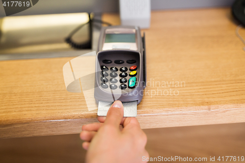 Image of close up of hand inserting bank card to terminal