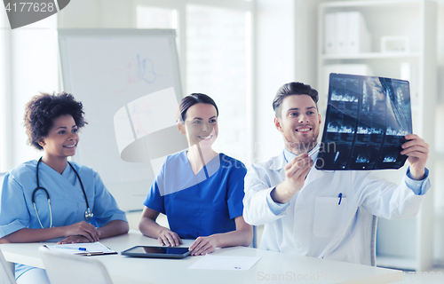 Image of group of happy doctors discussing x-ray image