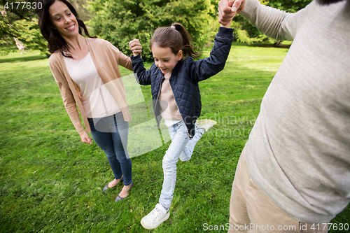 Image of happy family walking in summer park and having fun