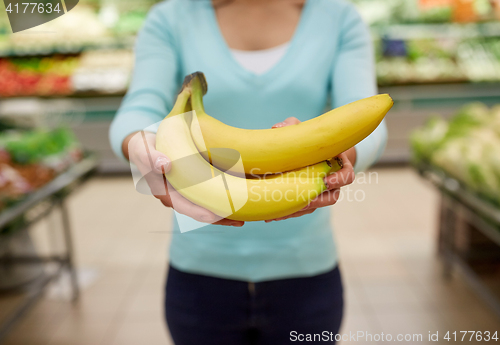 Image of woman with bananas at grocery store