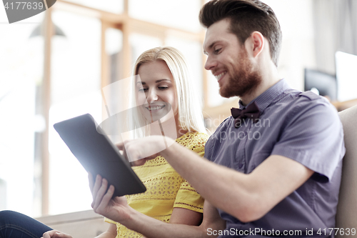 Image of happy creative team with tablet pc in office