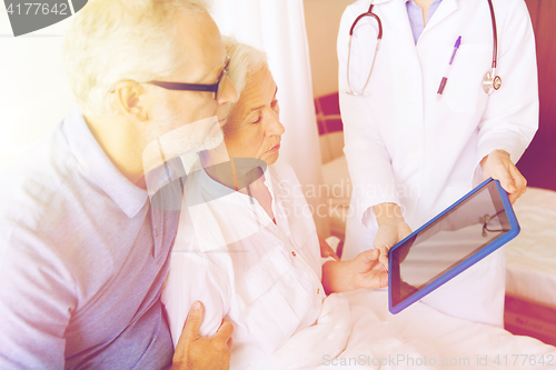 Image of senior woman and doctor with tablet pc at hospital