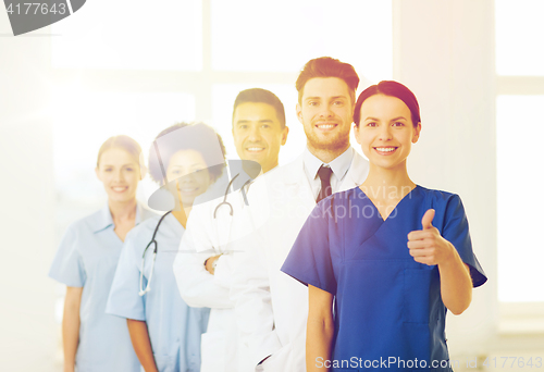 Image of happy doctors showing thumbs up at hospital