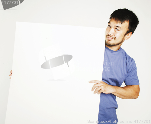 Image of pretty cool asian man holding empty white plate smiling