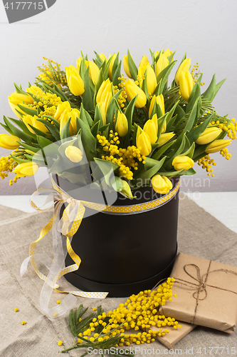 Image of Bright spring bouquet of tulips and mimosa flowers