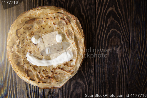 Image of Fried tasty smiling pancakes