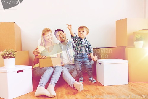 Image of happy family with boxes moving to new home