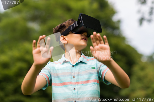 Image of boy with virtual reality headset outdoors