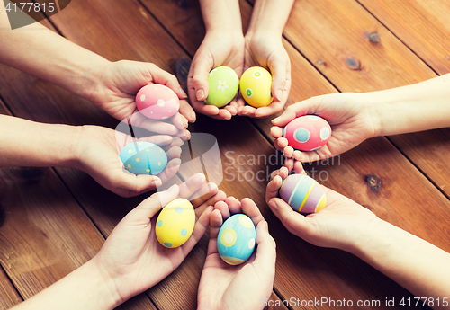 Image of close up of woman hands with colored easter eggs