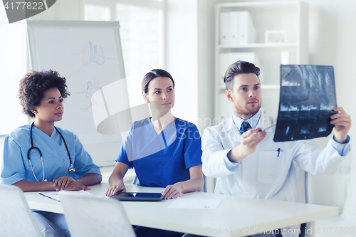 Image of group of doctors discussing x-ray image