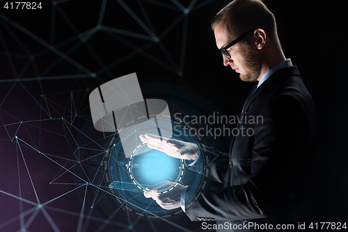 Image of businessman with light above transparent tablet pc