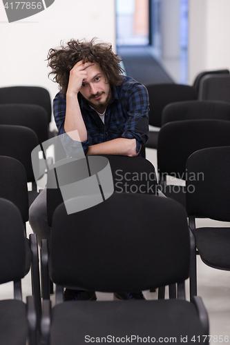 Image of A student sits alone  in a classroom