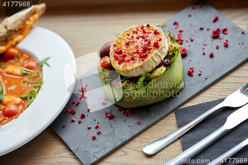 Image of goat cheese salad with vegetables at restaurant