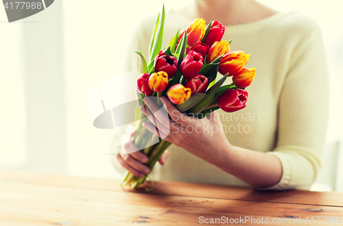 Image of close up of woman holding tulip flowers