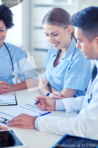 Image of group of happy doctors meeting at hospital office