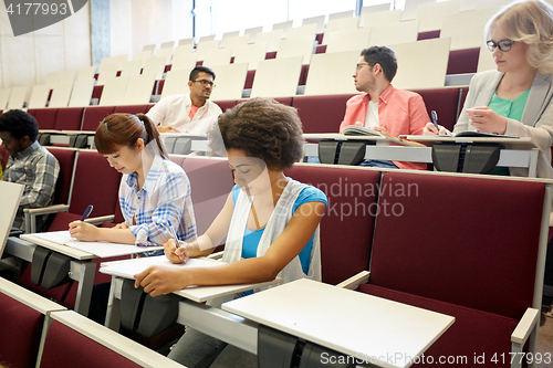 Image of group of students with notebooks at lecture hall